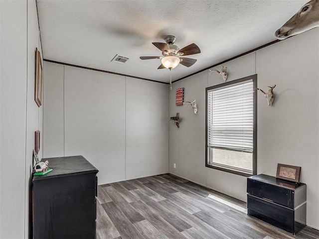28737 Oakwood Meadows Dr, Cashion, OK 73016 - spare room featuring visible vents, ceiling fan, wood finished floors, and a textured ceiling