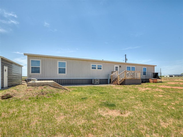 28737 Oakwood Meadows Dr, Cashion, OK 73016 - rear view of property with a wooden deck, cooling unit, and a lawn