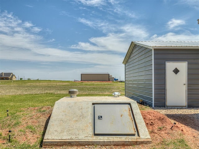 28737 Oakwood Meadows Dr, Cashion, OK 73016 - view of storm shelter featuring a lawn and an outdoor structure