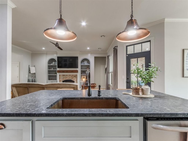 kitchen with a sink, dishwasher, hanging light fixtures, and open floor plan