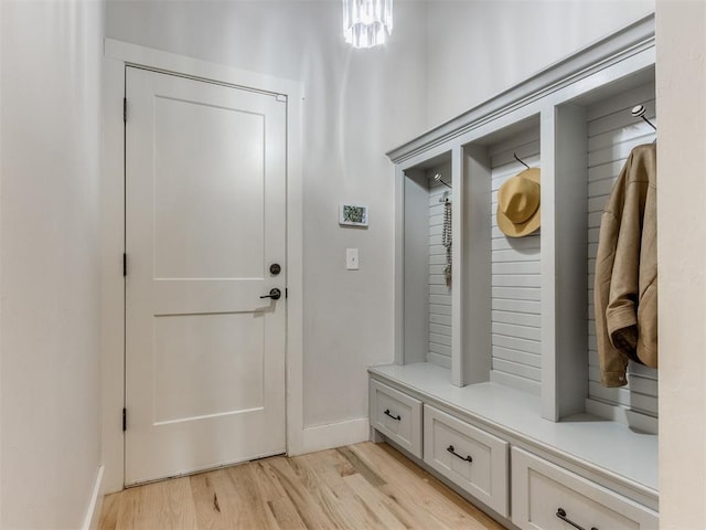 mudroom featuring baseboards and light wood finished floors