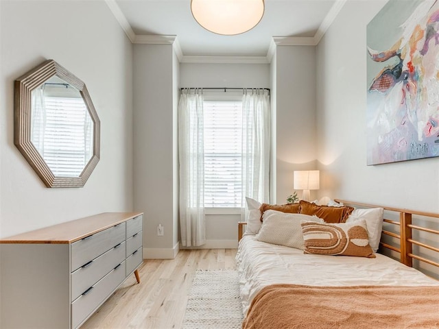bedroom with crown molding, baseboards, multiple windows, and light wood-style flooring