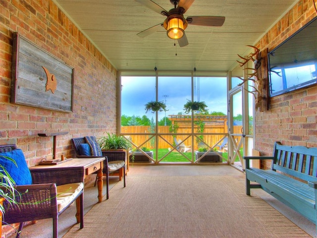 sunroom / solarium with a ceiling fan