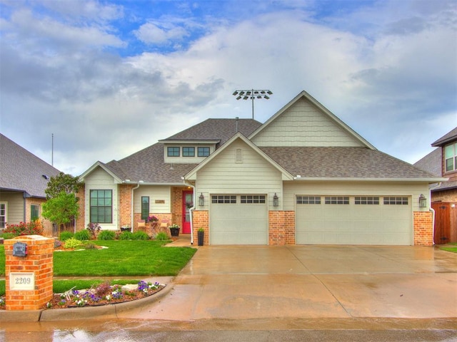 2209 Marjorie Ln, Yukon, OK 73099 - craftsman-style house with brick siding, an attached garage, driveway, and a front lawn