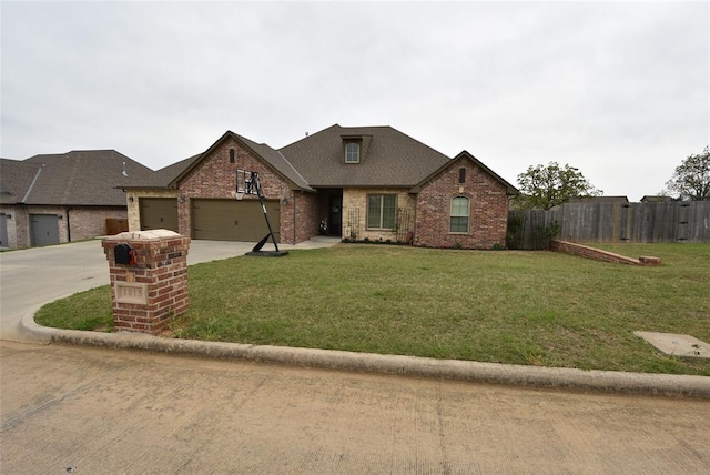 view of front facade featuring a front yard, brick siding, fence, and an attached garage