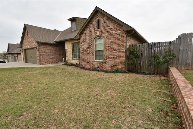 view of front of house featuring a front yard, a garage, fence, concrete driveway, and brick siding