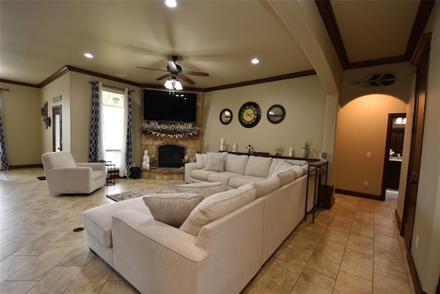 living area featuring arched walkways, ceiling fan, crown molding, and recessed lighting