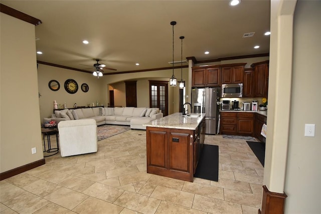 kitchen with crown molding, arched walkways, recessed lighting, a sink, and stainless steel appliances