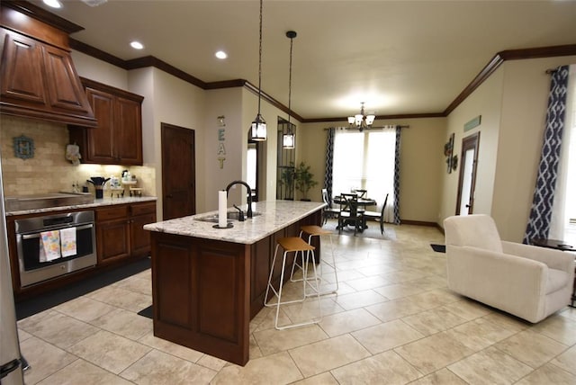kitchen with custom exhaust hood, a sink, ornamental molding, stainless steel oven, and backsplash