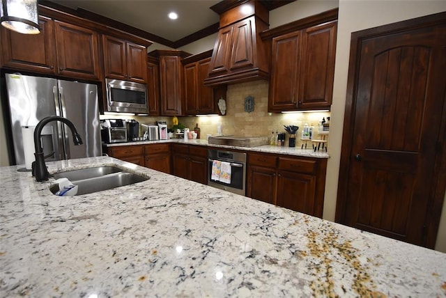 kitchen with stainless steel appliances, custom exhaust hood, light stone countertops, and a sink