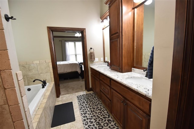 bathroom with double vanity, tile patterned floors, ensuite bathroom, a bath, and a sink
