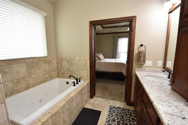 bathroom with tile patterned floors, a jetted tub, vanity, and ensuite bath