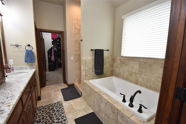 bathroom featuring a jetted tub and vanity
