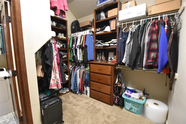 spacious closet with washer / clothes dryer and carpet floors