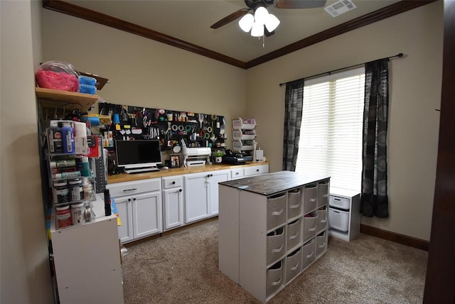 kitchen featuring dark colored carpet, ornamental molding, a ceiling fan, wooden counters, and visible vents