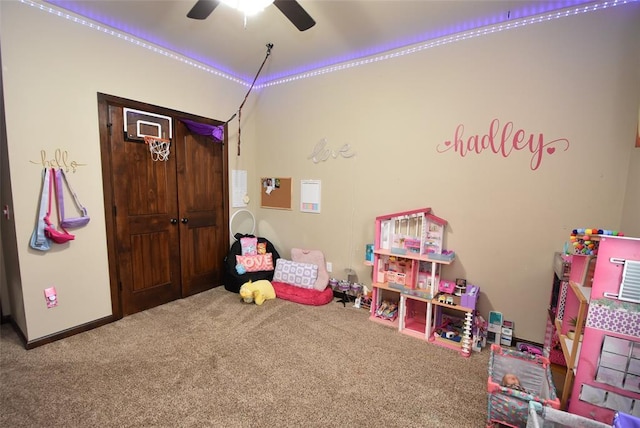 game room with carpet floors, ceiling fan, and baseboards