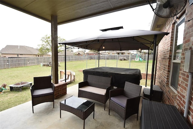 view of patio featuring a gazebo, a fenced backyard, and an outdoor hangout area