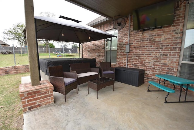 view of patio / terrace with a trampoline and fence