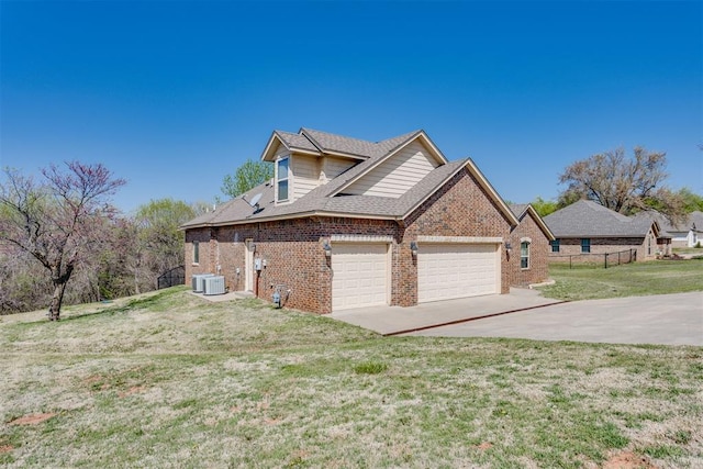 3719 Black Forrest Ct, Newcastle, OK 73065 - view of side of home featuring a yard, an attached garage, central air condition unit, brick siding, and driveway
