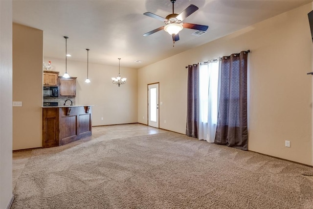 3719 Black Forrest Ct, Newcastle, OK 73065 - unfurnished living room with ceiling fan with notable chandelier, light colored carpet, baseboards, and visible vents