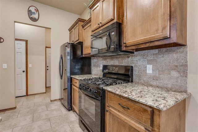 3719 Black Forrest Ct, Newcastle, OK 73065 - kitchen featuring light stone countertops, brown cabinetry, tasteful backsplash, black appliances, and baseboards