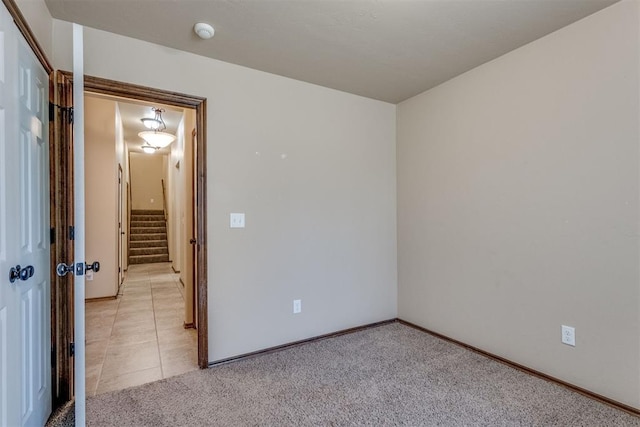 3719 Black Forrest Ct, Newcastle, OK 73065 - unfurnished room with light tile patterned floors, baseboards, stairway, and light colored carpet