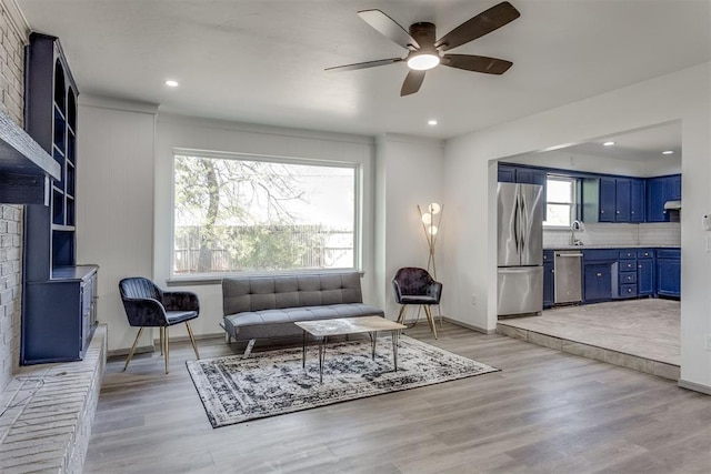 2621 NW 121st St, Oklahoma City, OK 73120 - living area featuring ceiling fan, light wood-style flooring, baseboards, a brick fireplace, and recessed lighting