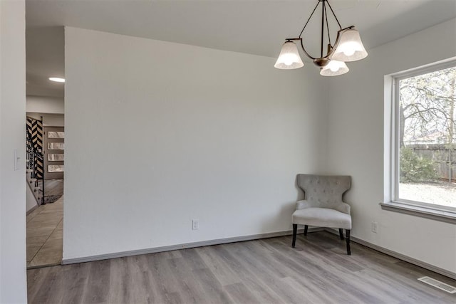 2621 NW 121st St, Oklahoma City, OK 73120 - unfurnished room featuring baseboards, a notable chandelier, wood finished floors, and visible vents