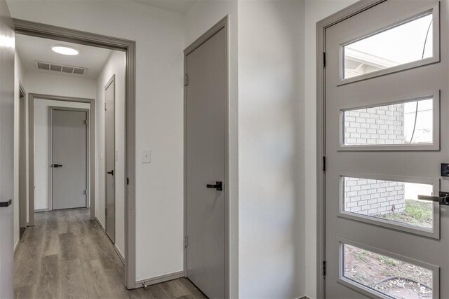 2621 NW 121st St, Oklahoma City, OK 73120 - corridor featuring baseboards, light wood-style flooring, and visible vents