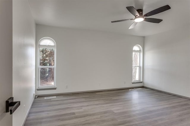 2621 NW 121st St, Oklahoma City, OK 73120 - unfurnished room with ceiling fan, baseboards, and wood finished floors