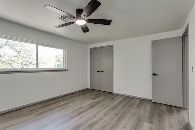 2621 NW 121st St, Oklahoma City, OK 73120 - unfurnished bedroom with light wood finished floors, a ceiling fan, visible vents, and a closet