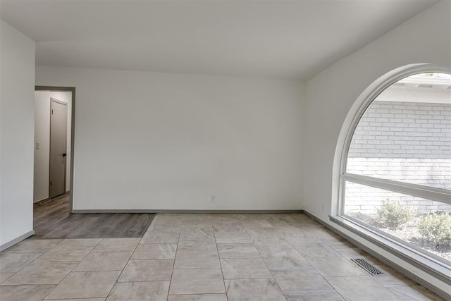 2621 NW 121st St, Oklahoma City, OK 73120 - spare room with a healthy amount of sunlight, baseboards, and visible vents