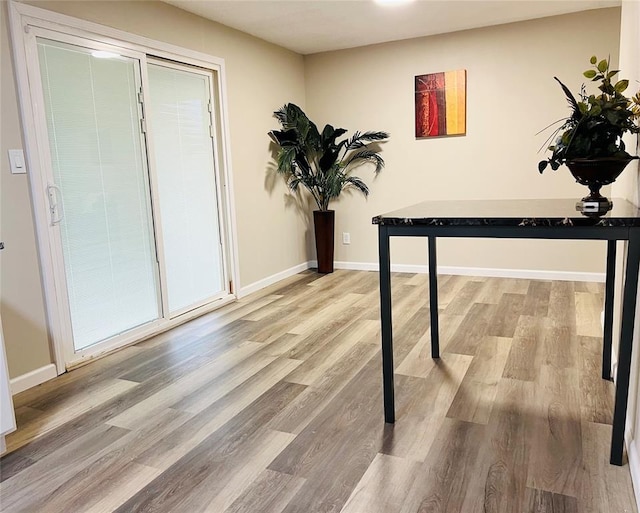 interior space featuring baseboards and wood finished floors