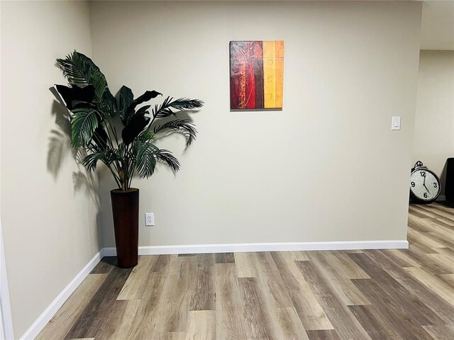 interior space with wood finished floors and baseboards