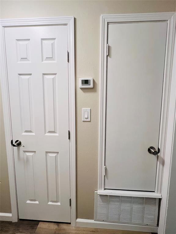 details featuring visible vents, baseboards, and wood finished floors