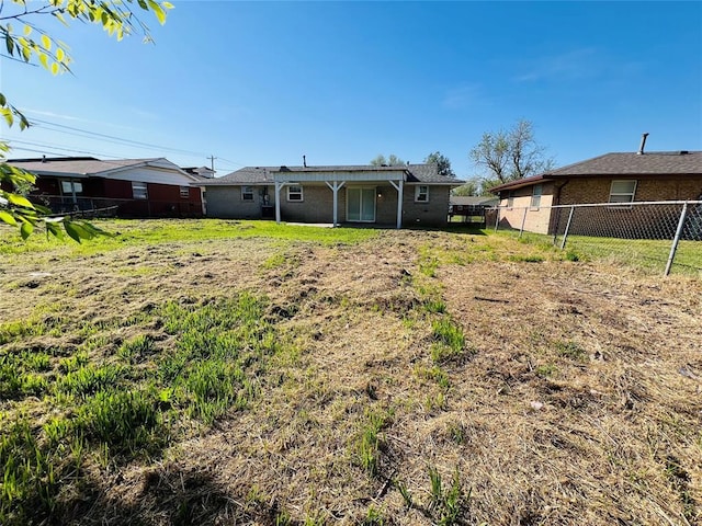 back of property featuring brick siding and fence