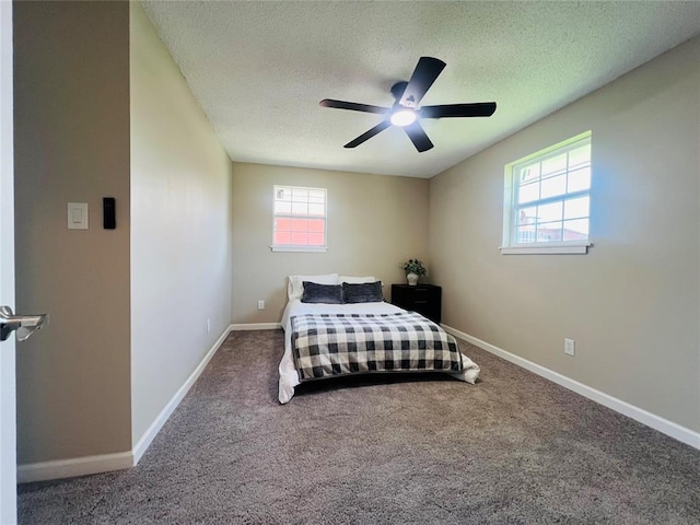 carpeted bedroom featuring a textured ceiling, a ceiling fan, and baseboards