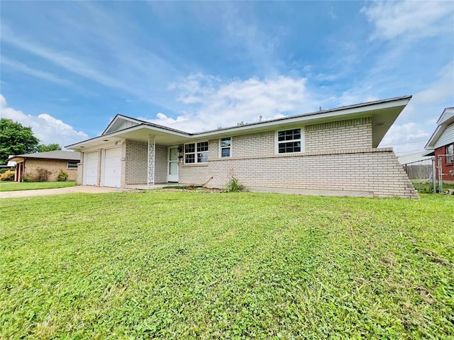 105 SW 6th St, Moore, OK 73160 - view of front facade with brick siding, an attached garage, concrete driveway, and a front yard