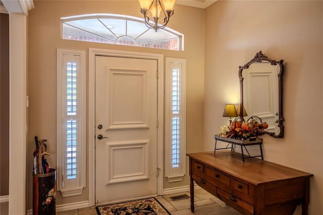 foyer with plenty of natural light, visible vents, a chandelier, and ornamental molding