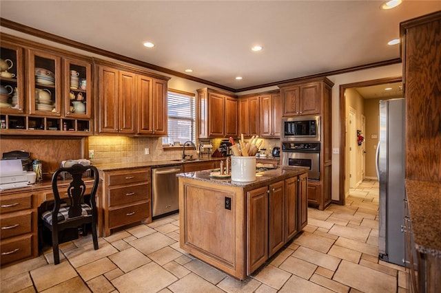 kitchen with tasteful backsplash, dark stone countertops, stainless steel appliances, and a sink