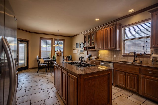 kitchen featuring backsplash, plenty of natural light, stainless steel appliances, and a sink