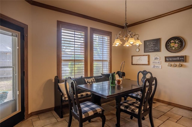 dining room with a notable chandelier, baseboards, and ornamental molding