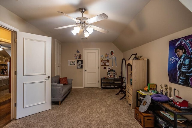 living area with carpet floors, a ceiling fan, and lofted ceiling