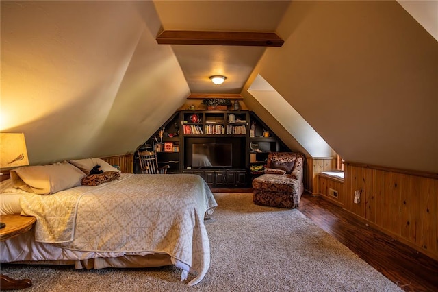 bedroom with vaulted ceiling, wood finished floors, and wood walls