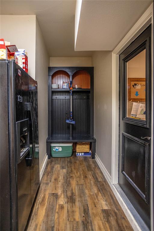 mudroom with baseboards and wood finished floors