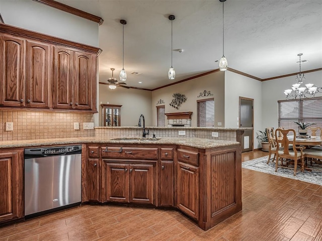 kitchen featuring stainless steel dishwasher, tasteful backsplash, a sink, and light wood-type flooring