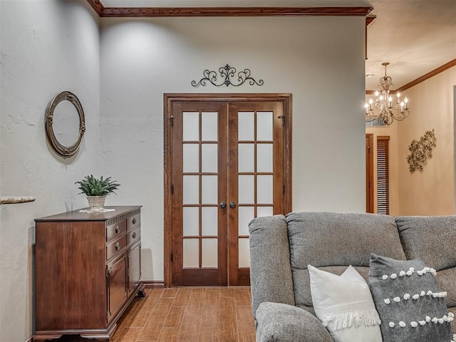 entryway featuring a chandelier, ornamental molding, and french doors