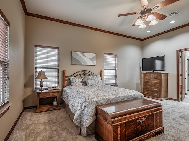 carpeted bedroom with visible vents, baseboards, and crown molding