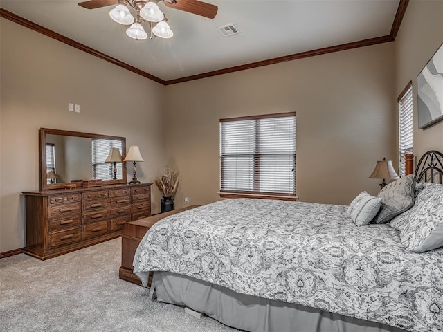 bedroom featuring visible vents, light carpet, ornamental molding, and multiple windows