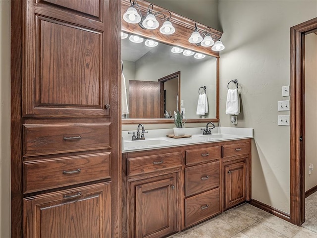 bathroom with double vanity, tile patterned floors, and a sink